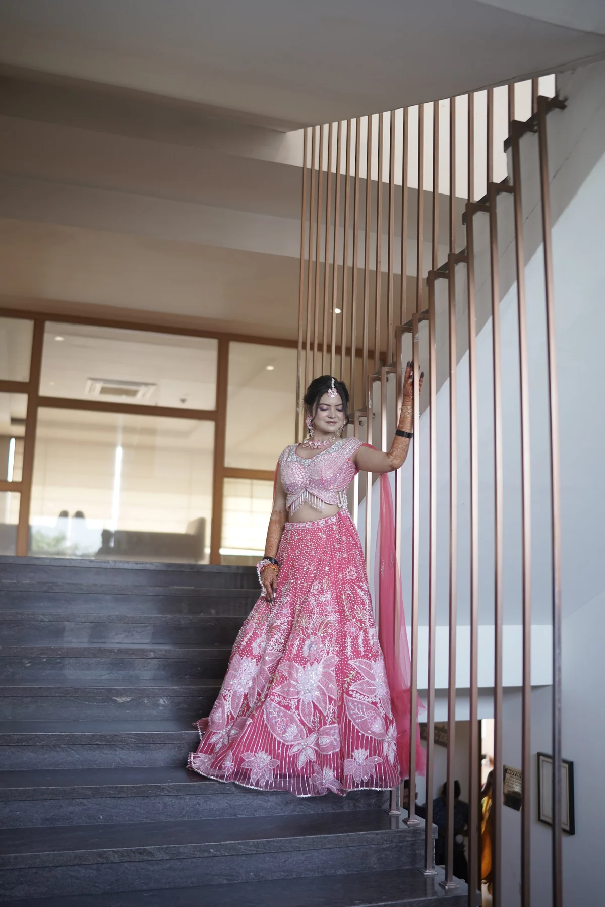 Bride Posing on Grand Palace Staircase Under Chandelier
