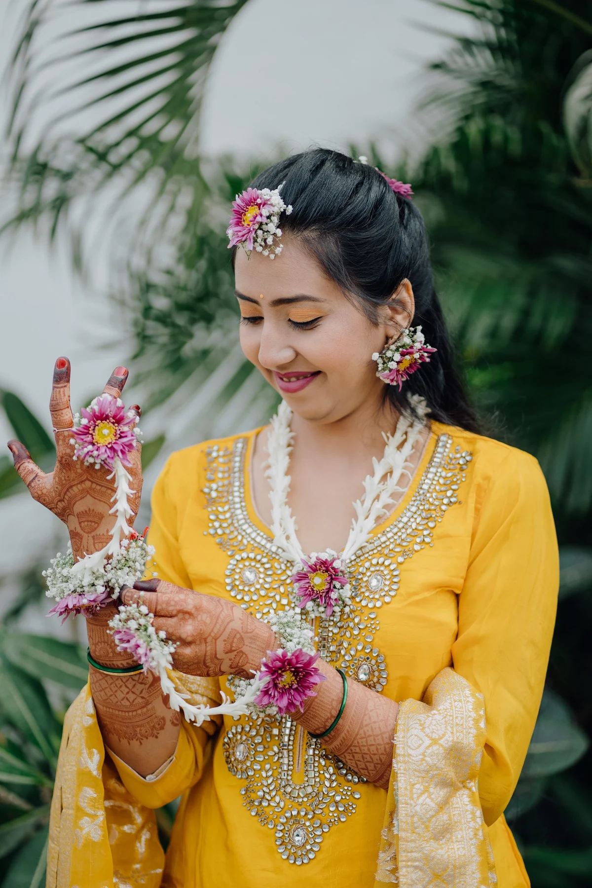 Bride Adorned in Delicate Floral Haldi Jewelry