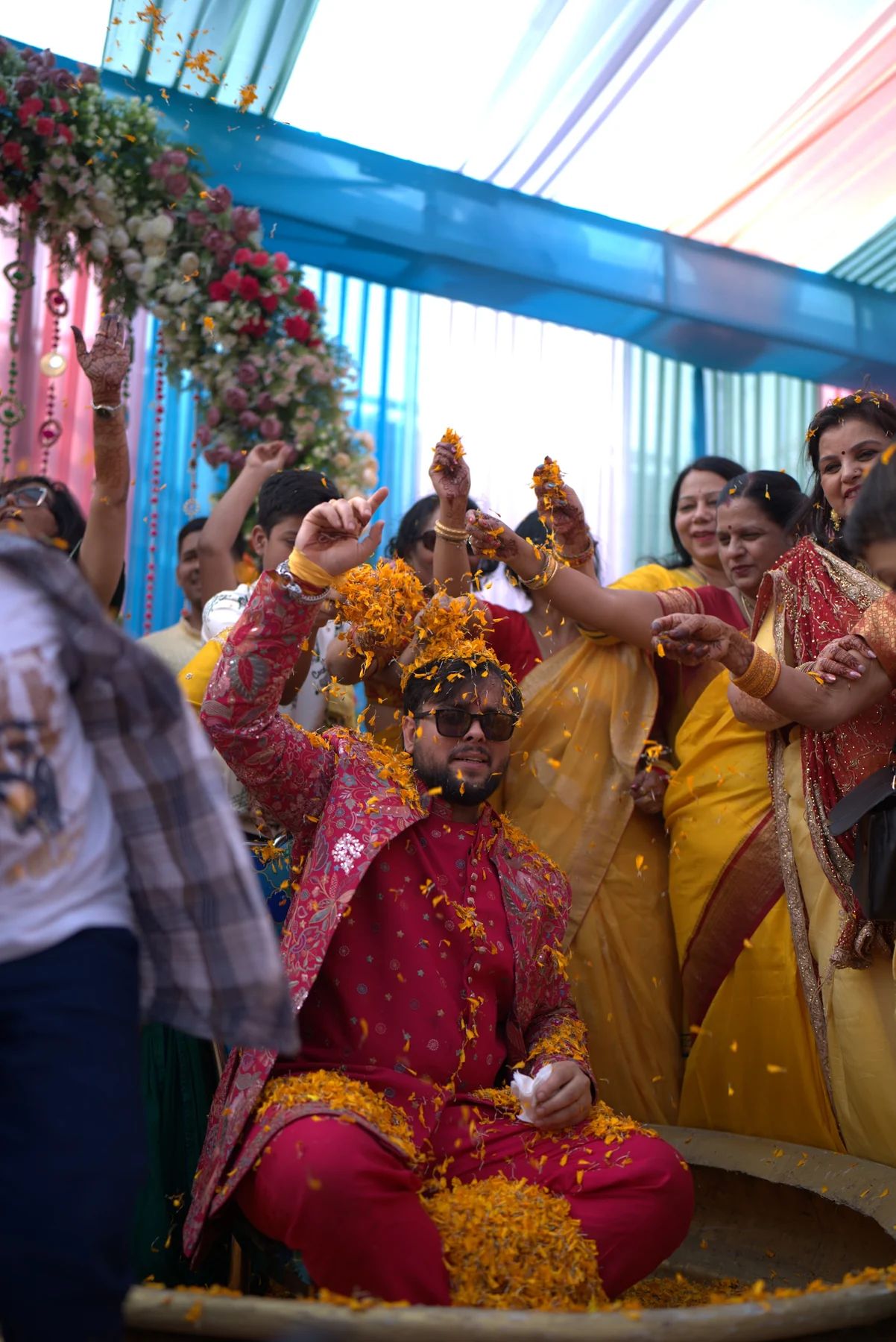 Groom in Royal Brass Urli Under Marigold Shower