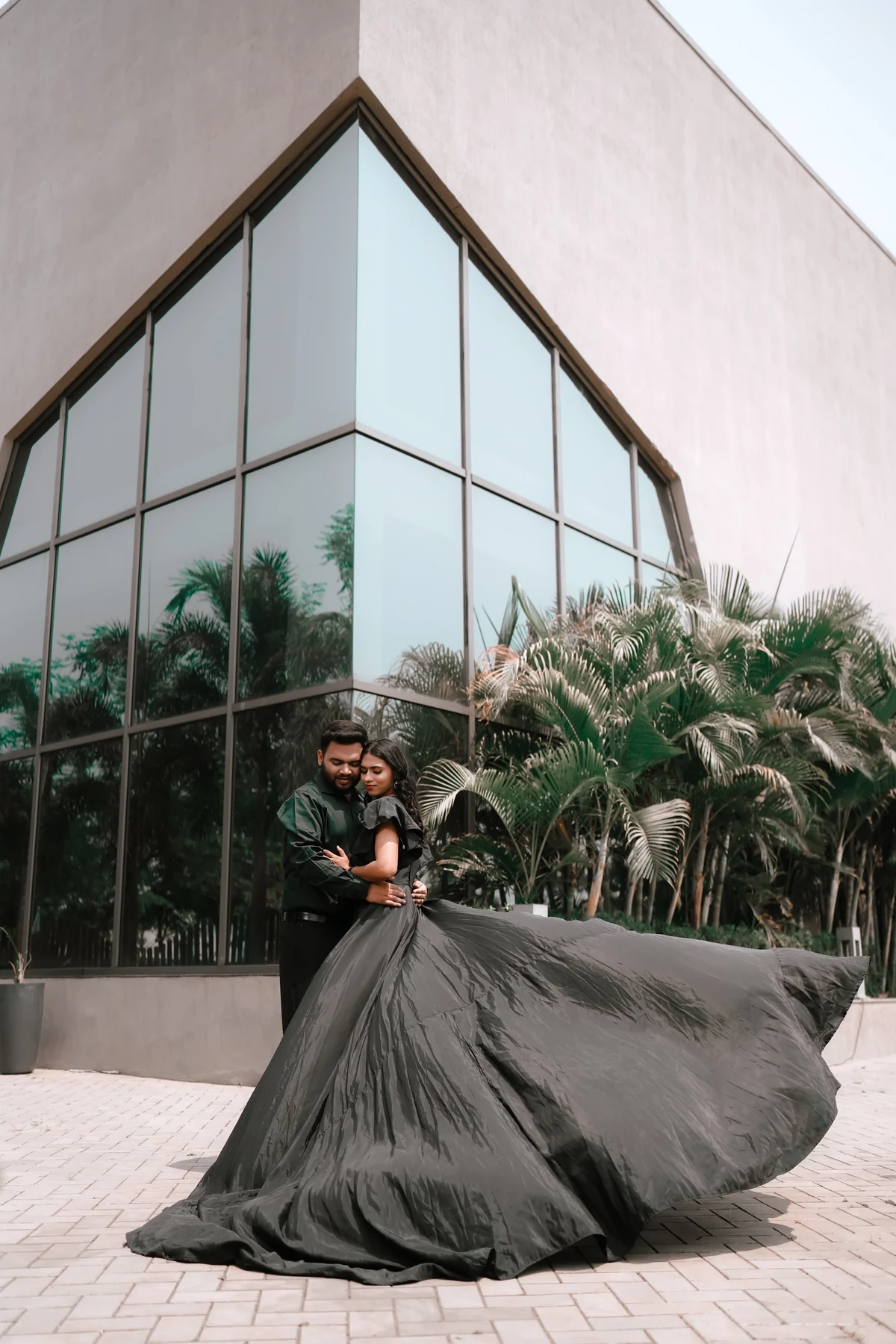 Couple Reflected in Modern Glass Architecture