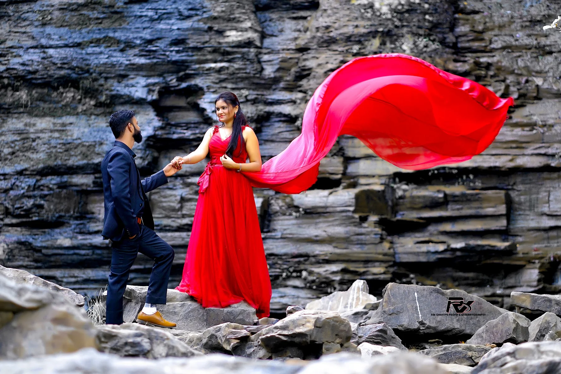 Pre-Wedding Couple in Flowing Red Gown on Canyon Rocks