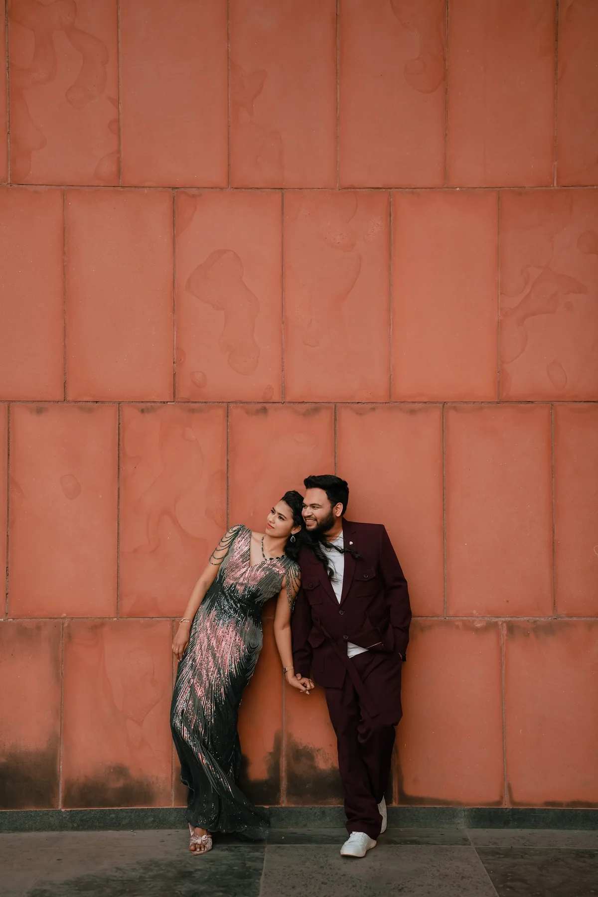 Couple Walking Along Heritage Terracotta Wall